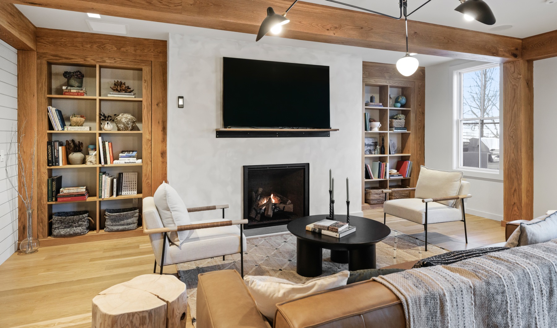 Resident lounge at our apartments for rent in Darien, CT, featuring wood grain floor paneling and a flat screen TV.