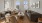 Model living room at our apartments for rent in Darien, CT, featuring wood grain floor paneling and a black leather couch.